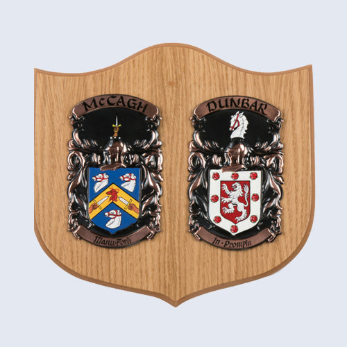 An image of a Bespoke Coat of Arms Shield made of Large Double Oak displaying the surnames MacCagh and Dunbar.